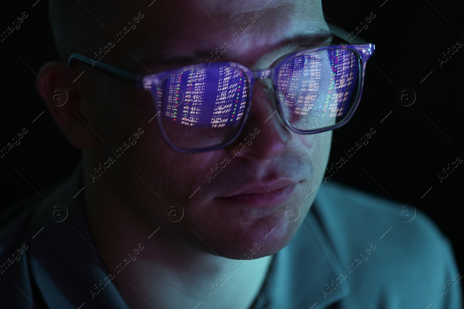 Young man wearing glasses with reflection on dark background, closeup Photo of Young man wearing glasses with reflection on dark background, closeup