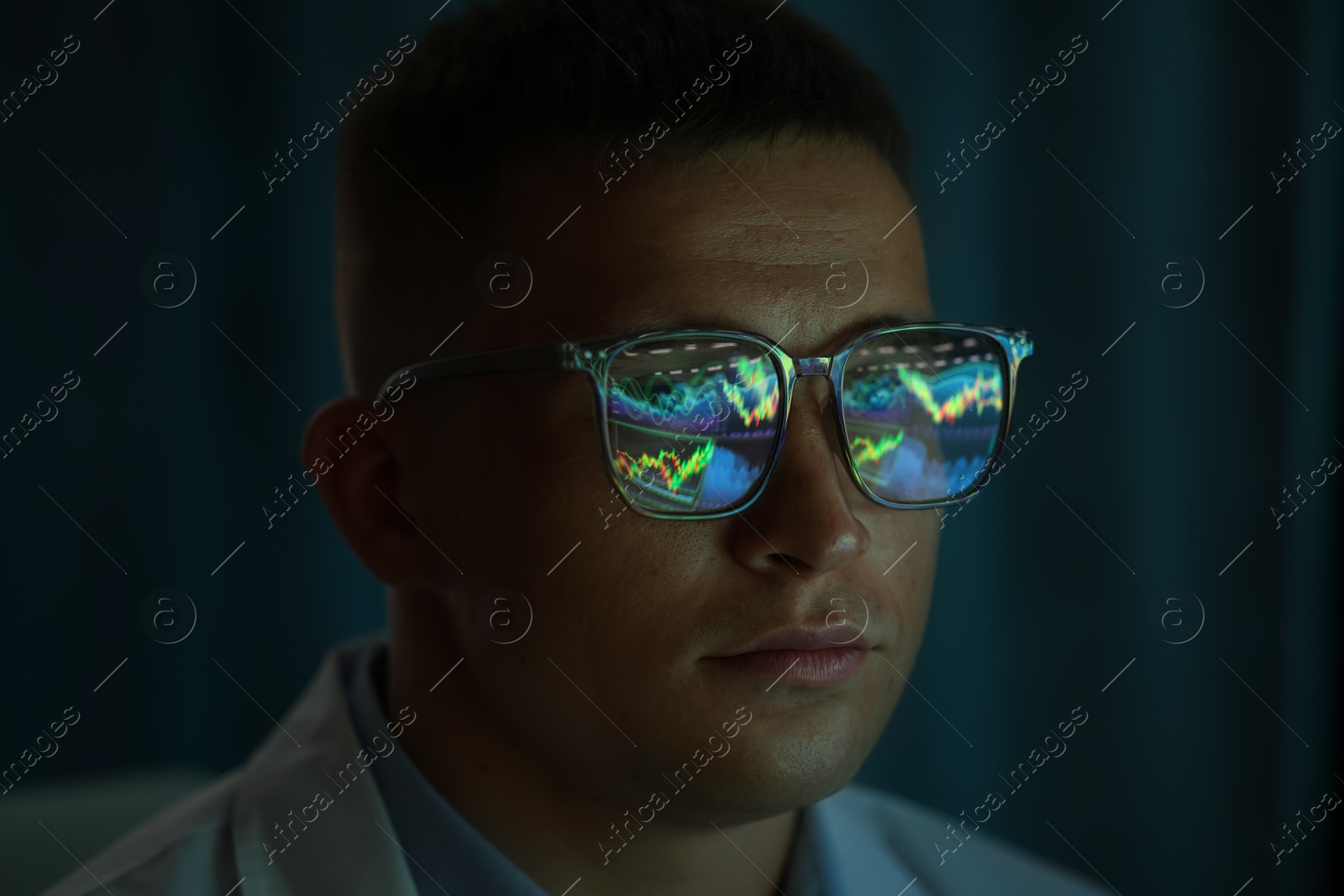 Young man wearing glasses with reflection on dark background, closeup Photo of Young man wearing glasses with reflection on dark background, closeup