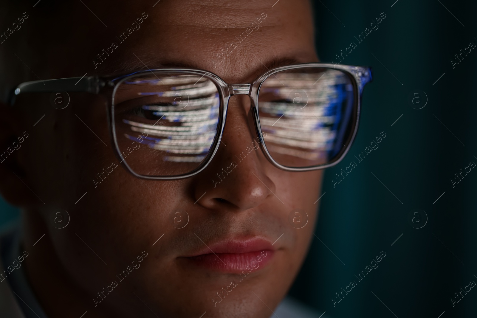 Young man wearing glasses with reflection on dark background, closeup Photo of Young man wearing glasses with reflection on dark background, closeup
