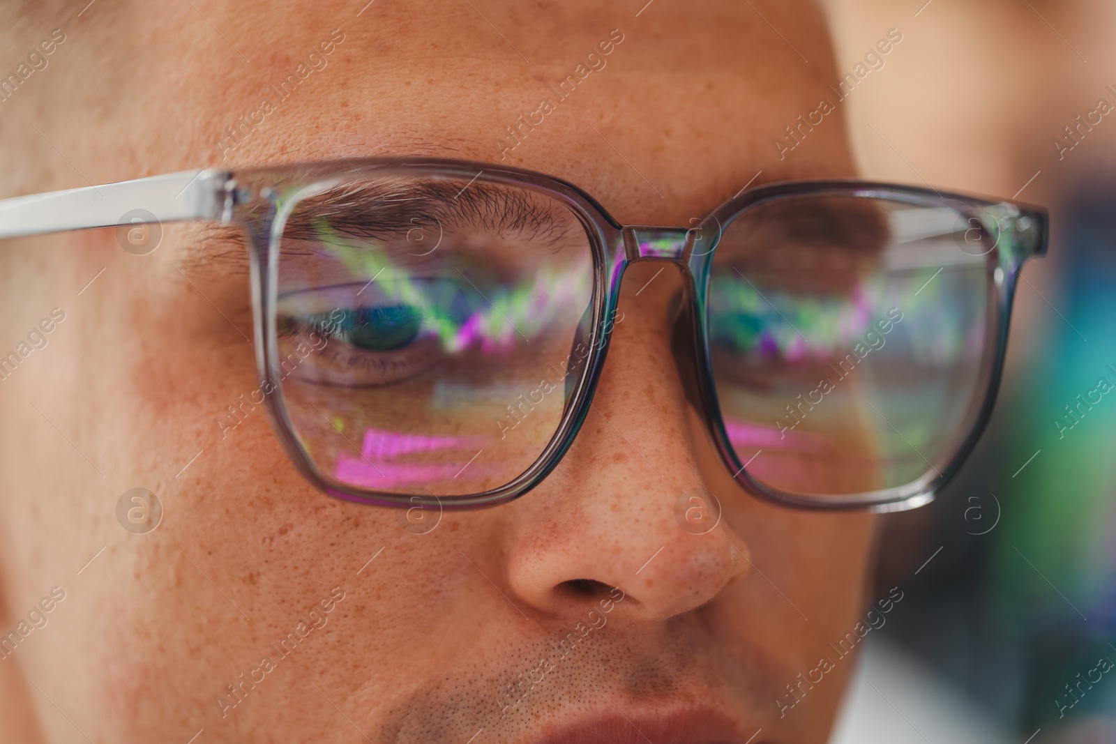Young man wearing glasses with reflection on blurred background, closeup Photo of Young man wearing glasses with reflection on blurred background, closeup