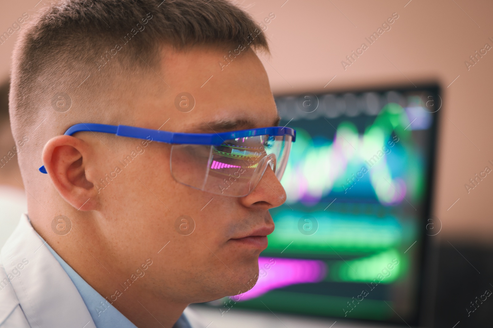 Young man wearing glasses with reflection on blurred background, closeup Photo of Young man wearing glasses with reflection on blurred background, closeup