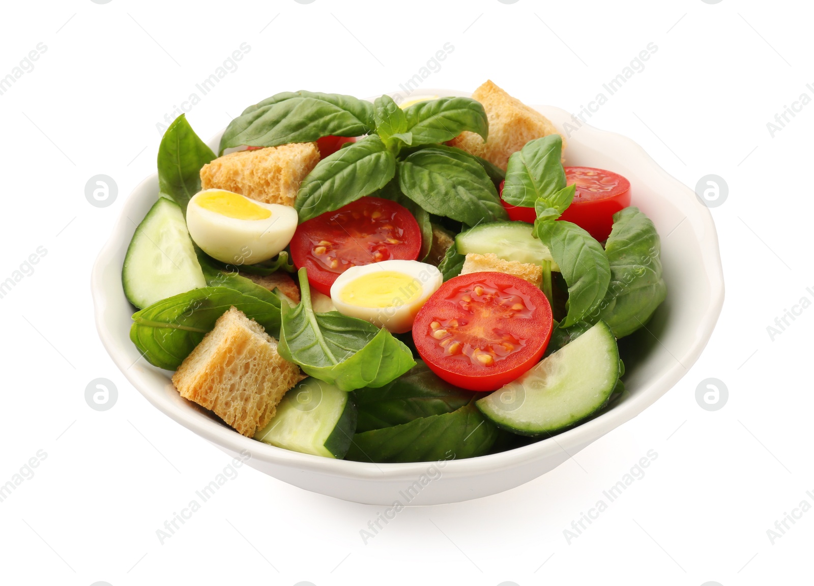 Photo of Tasty salad with croutons, tomatoes, cucumbers and basil isolated on white