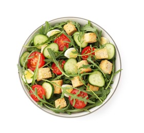 Photo of Tasty salad with croutons, cucumbers, tomatoes and arugula isolated on white, top view