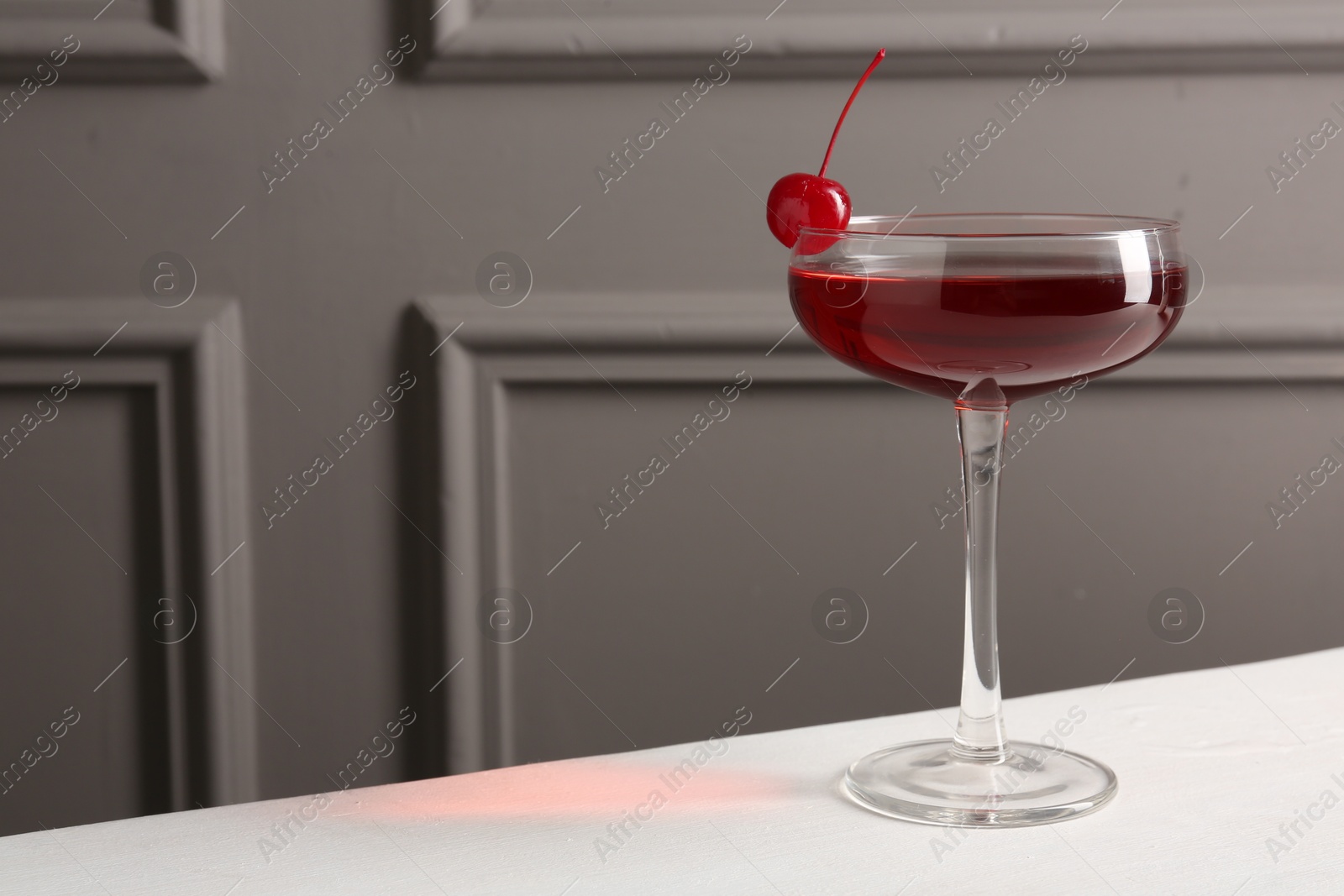 Tasty cherry cocktail on white table, closeup. Space for text Photo of Tasty cherry cocktail on white table, closeup. Space for text