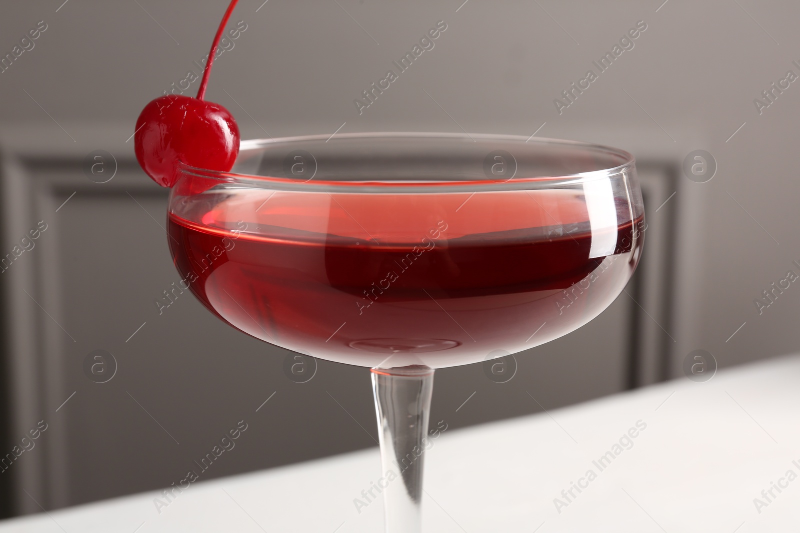 Tasty cherry cocktail on white table, closeup Photo of Tasty cherry cocktail on white table, closeup