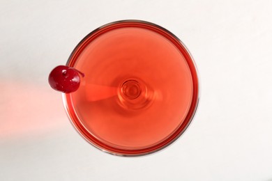 Photo of Tasty cherry cocktail on white table, top view