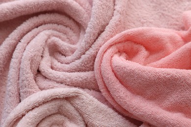 Photo of Soft pink towels as background, closeup view