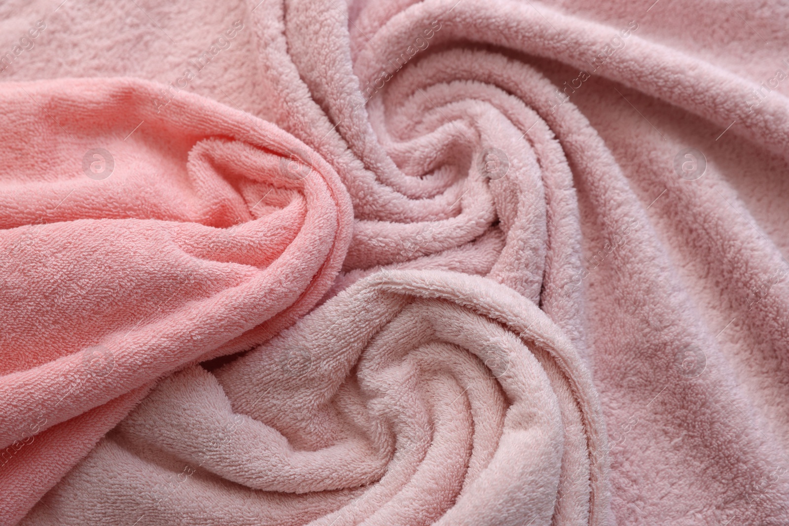 Photo of Soft pink towels as background, above view