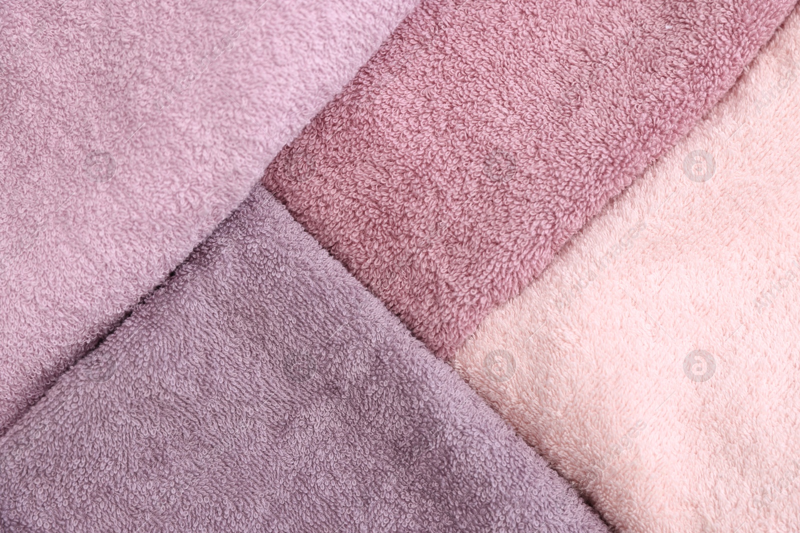 Photo of Soft pink towels as background, top view