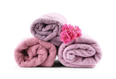 Photo of Rolled towels and flower isolated on white