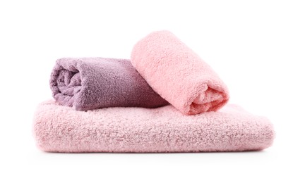 Photo of Rolled pink and purple towels isolated on white