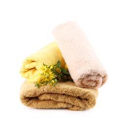 Photo of Soft towels and flowers isolated on white