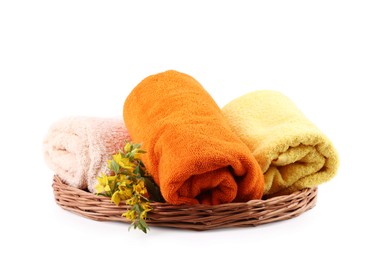 Photo of Rolled towels and flowers isolated on white