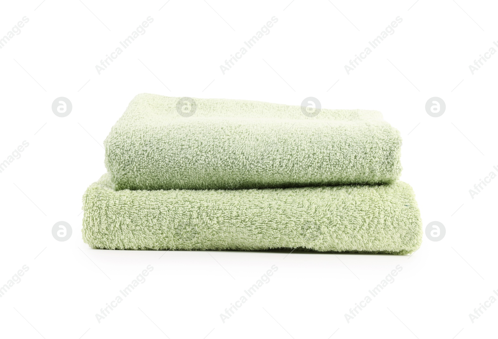 Photo of Stack of soft green towels isolated on white
