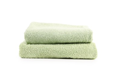 Photo of Stack of soft green towels isolated on white