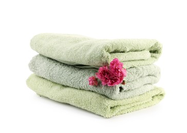 Photo of Stack of towels and flowers isolated on white