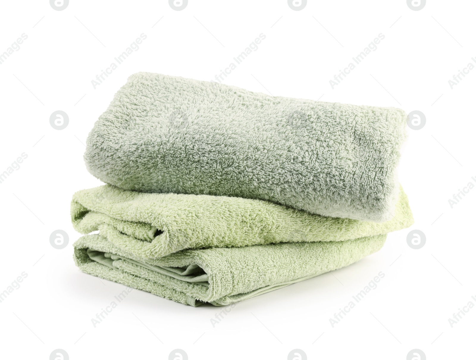 Photo of Stack of soft green towels isolated on white
