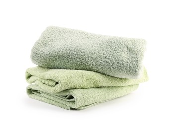 Photo of Stack of soft green towels isolated on white