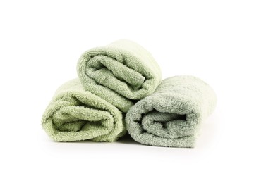 Photo of Rolled green towels isolated on white. Home textile