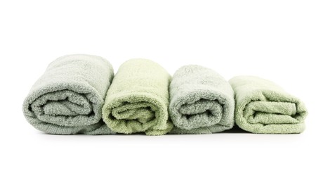 Photo of Rolled green towels isolated on white. Home textile
