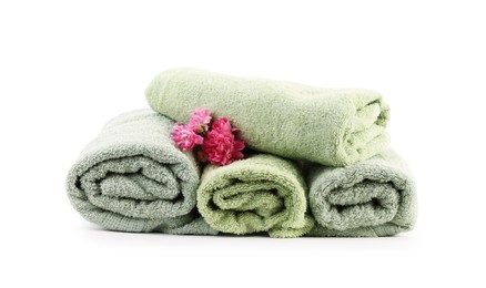 Photo of Rolled towels and flowers isolated on white