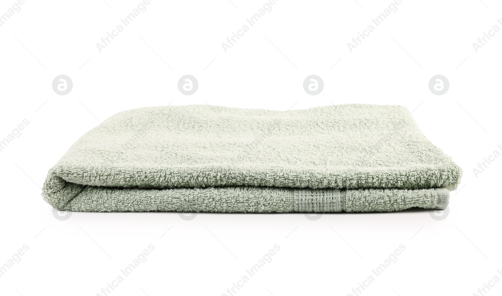 Photo of One folded green towel isolated on white