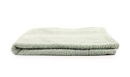 Photo of One folded green towel isolated on white