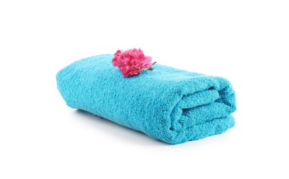 Photo of One rolled blue towel and flower isolated on white