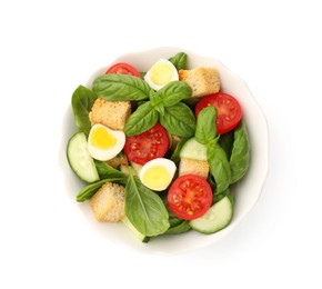 Photo of Tasty salad with croutons, tomatoes, cucumbers and basil isolated on white, top view