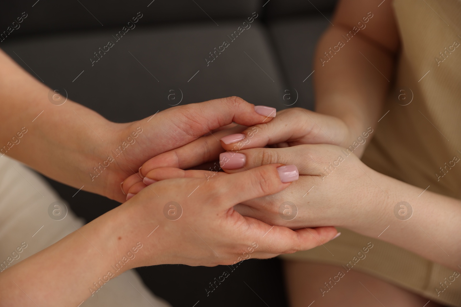 Photo of Friends holding hands after apology, closeup view