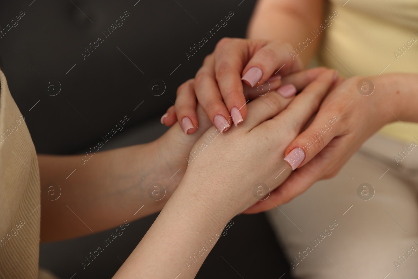 Photo of Friends holding hands after apology, closeup view