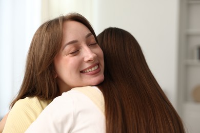 Photo of Happy friends hugging after apology at home
