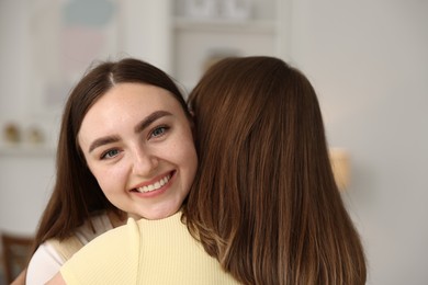 Photo of Happy friends hugging after apology at home