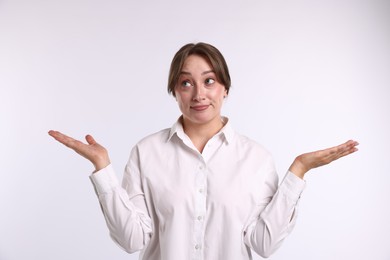 Photo of Portrait of confused woman apologizing on white background