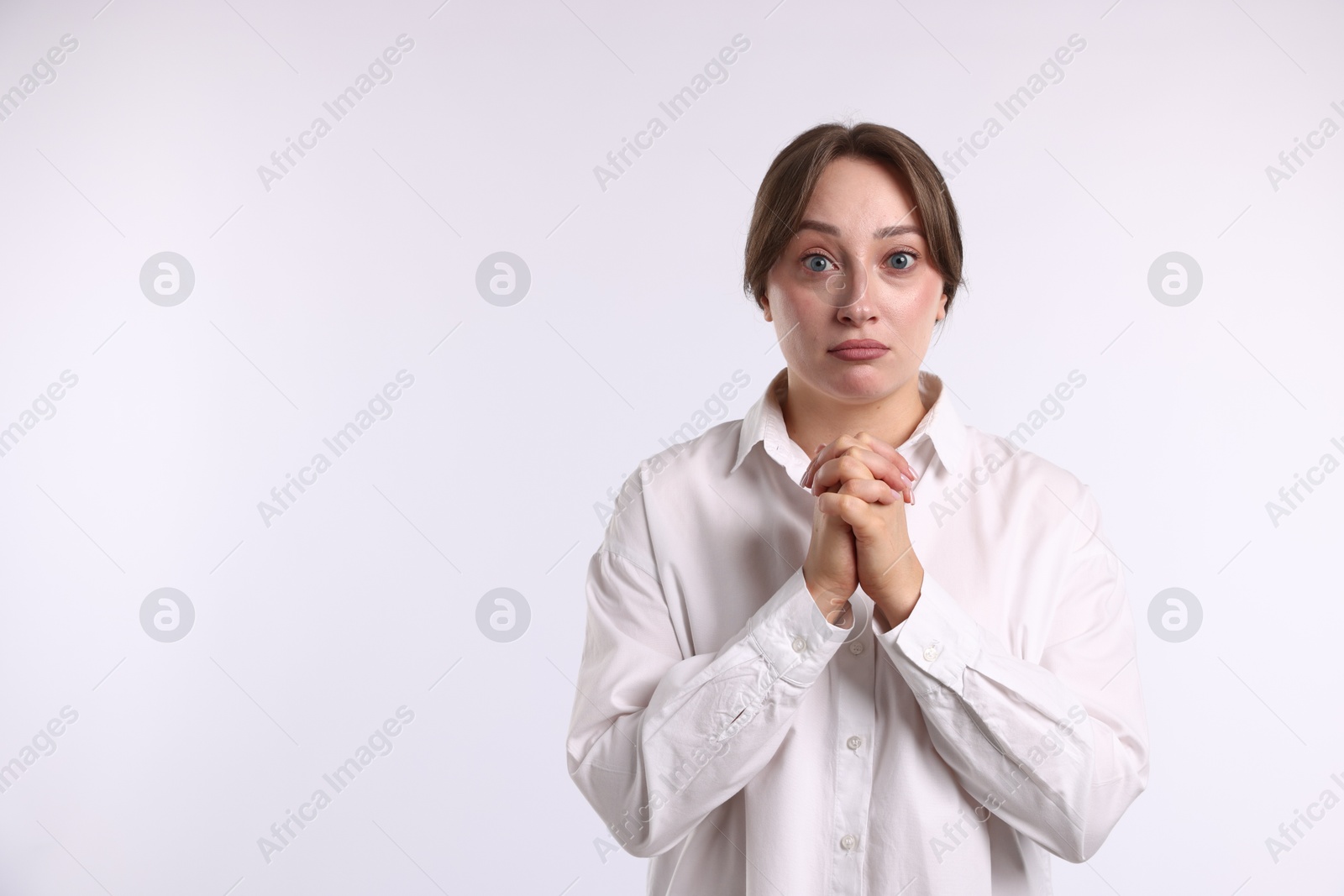 Woman apologizing on white background. Space for text Photo of Woman apologizing on white background. Space for text