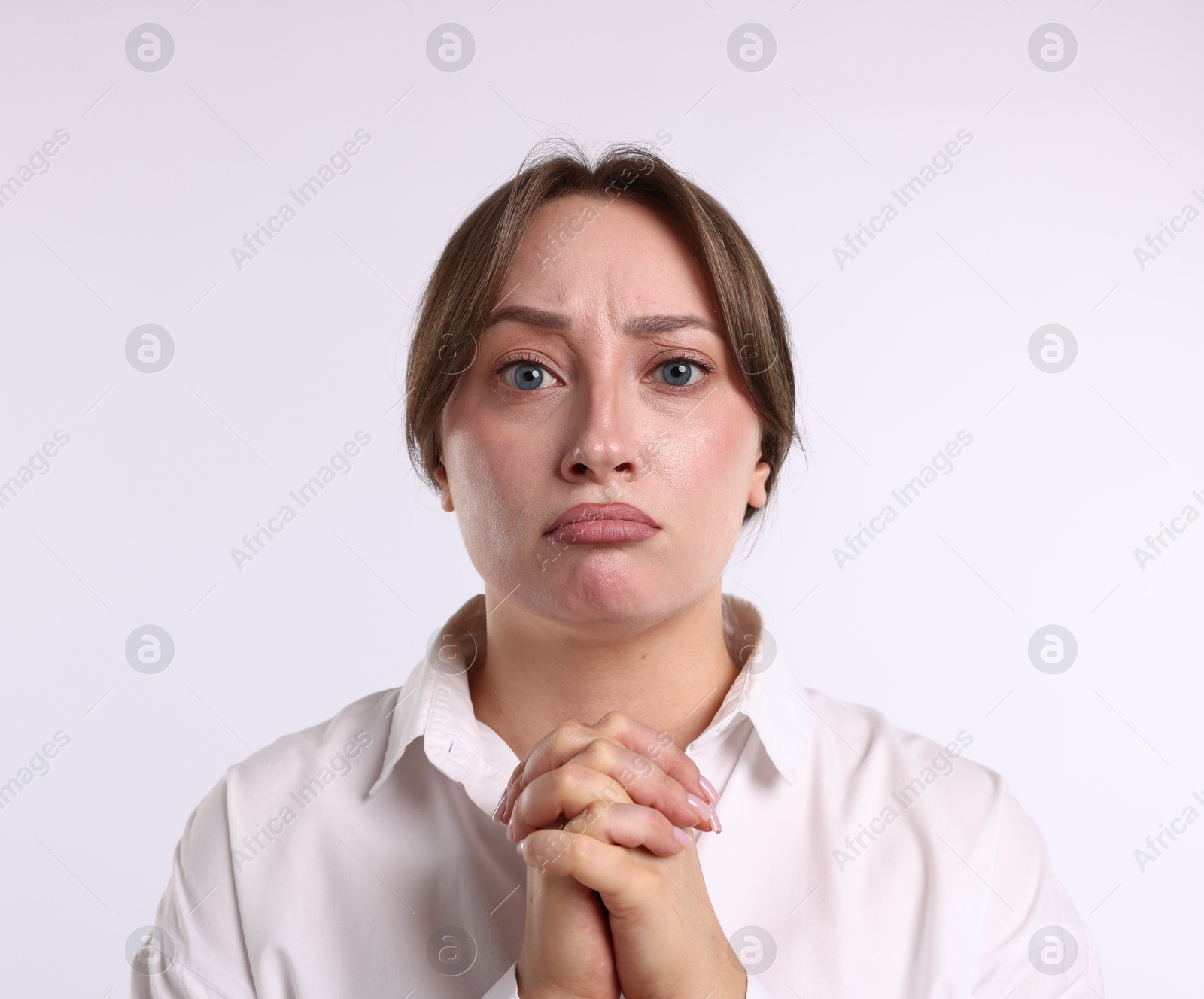 Portrait of woman apologizing on white background Photo of Portrait of woman apologizing on white background