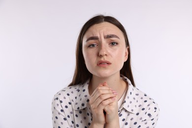 Photo of Portrait of woman apologizing on white background