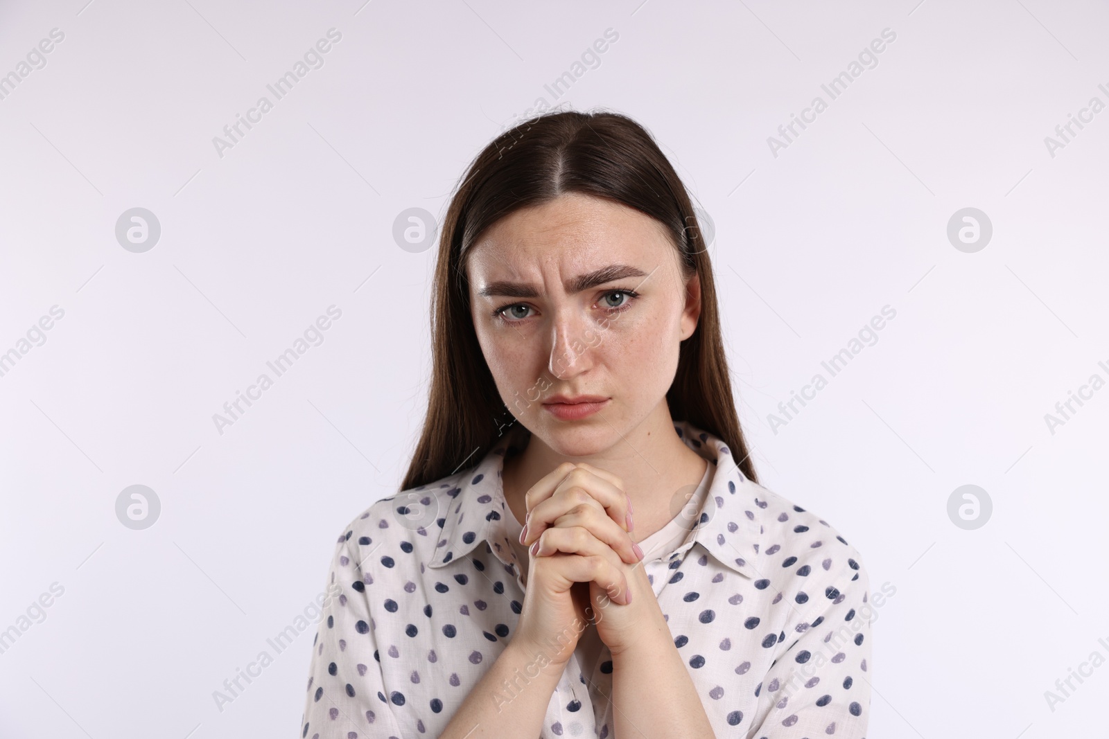 Portrait of woman apologizing on white background Photo of Portrait of woman apologizing on white background