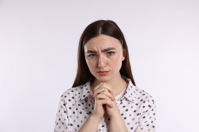 Photo of Portrait of woman apologizing on white background