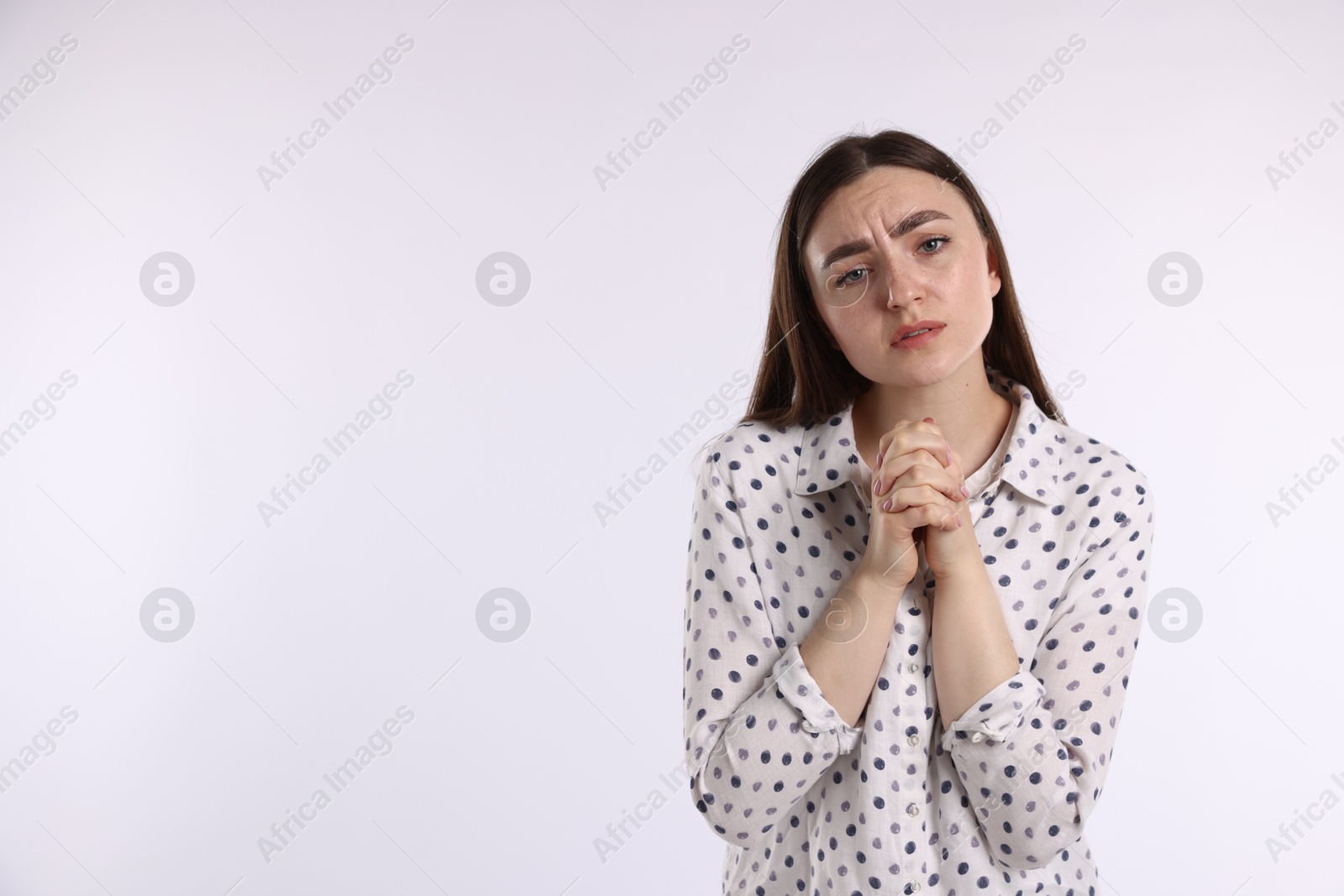 Woman apologizing on white background. Space for text Photo of Woman apologizing on white background. Space for text