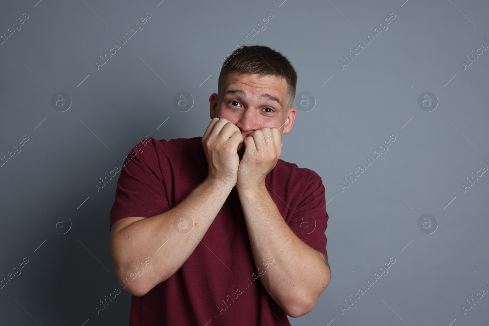 Man suffering from panic attack on grey background Photo of Man suffering from panic attack on grey background