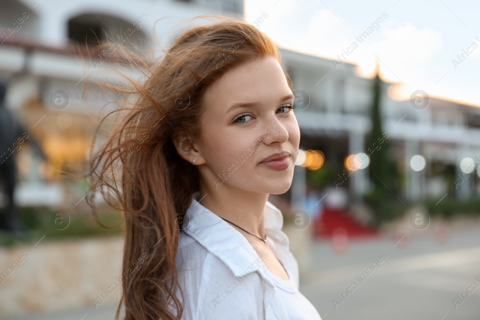 Photo of Portrait of beautiful girl near hotel outdoors