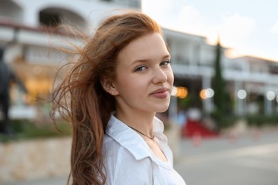 Photo of Portrait of beautiful girl near hotel outdoors