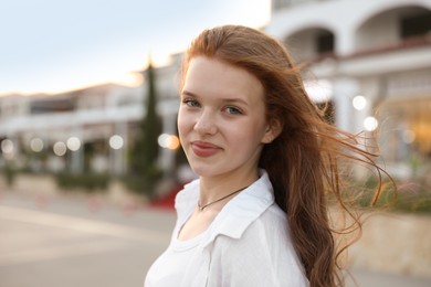 Photo of Portrait of beautiful girl near hotel outdoors