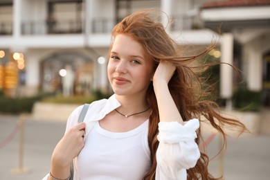 Photo of Portrait of beautiful girl near hotel outdoors