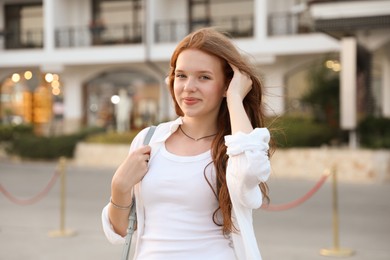 Photo of Portrait of beautiful girl near hotel outdoors