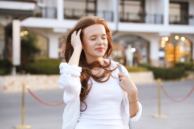 Photo of Portrait of beautiful girl near hotel outdoors