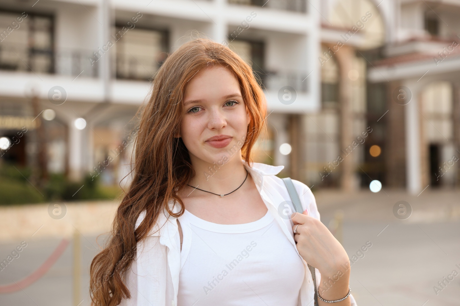 Photo of Portrait of beautiful girl near hotel outdoors
