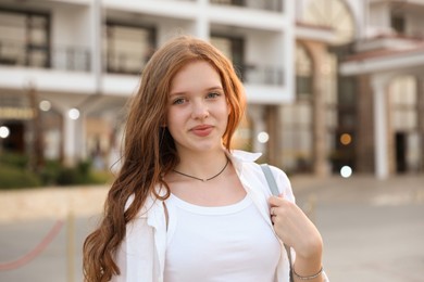 Photo of Portrait of beautiful girl near hotel outdoors