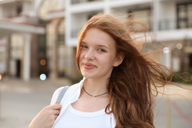 Photo of Portrait of beautiful girl near hotel outdoors